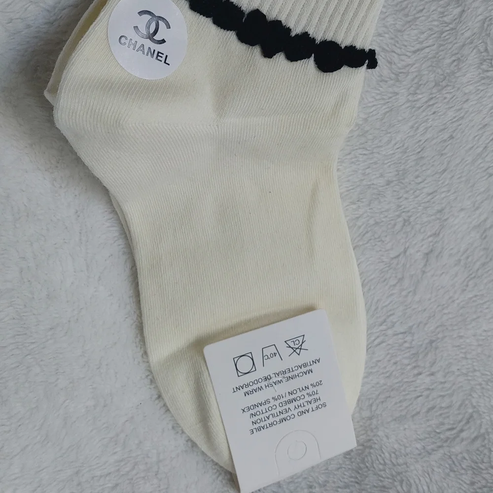 2 Pair of socks. 1 Cream trimmed in Black, 1 Black trimmed In Cream Women Size 7